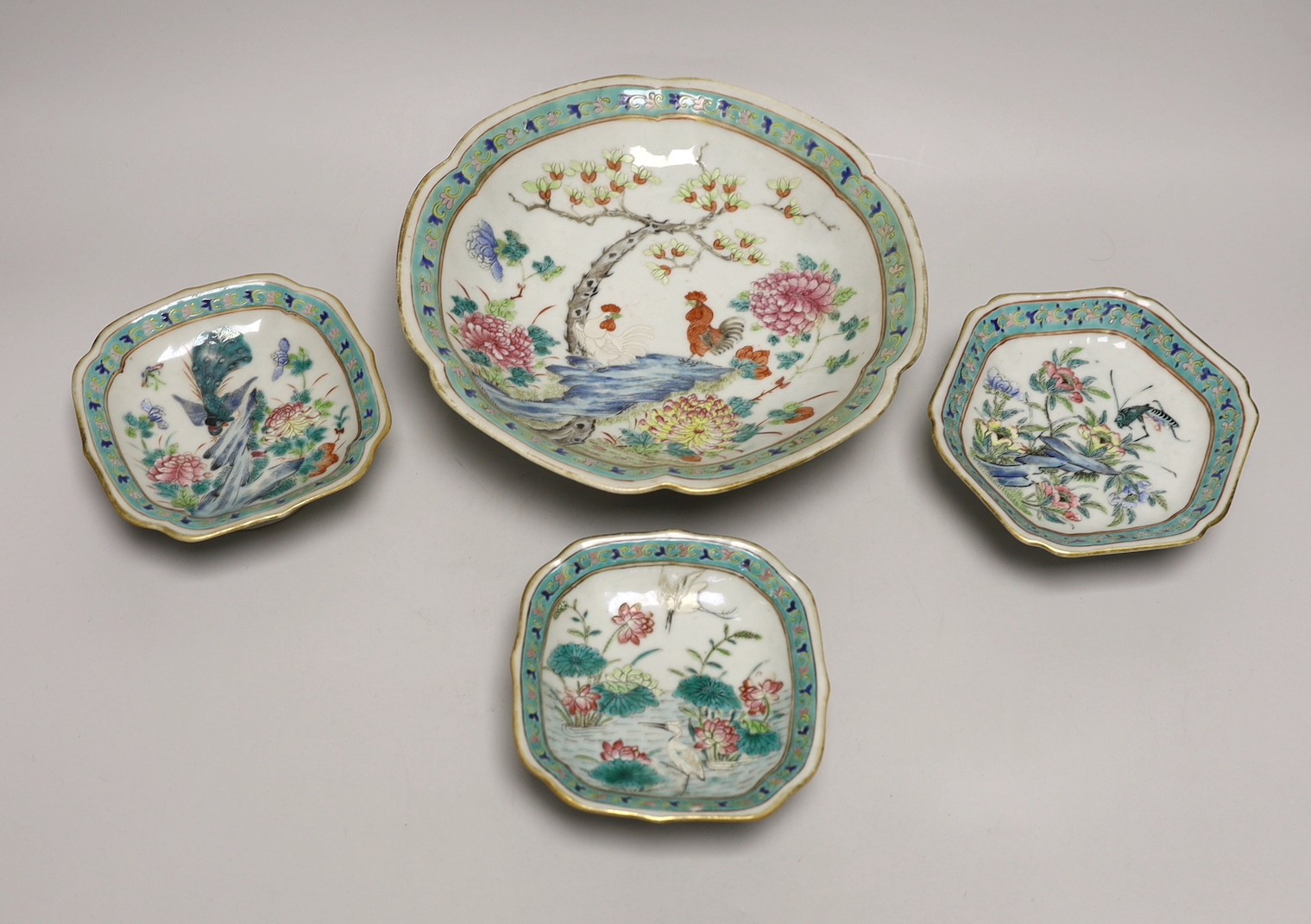 A set of Chinese famille rose bird or insect and flowers dishes, Tongzhi mark and period (1862-74), largest 23 cm wide